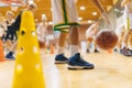 Young School Boys Practicing Bouncing Basketballs on School Wooden Court