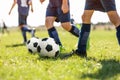 Young School Footballers Dribbling Around Cones in Drill on a Sunny Day