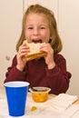 Young school girl eating lunch