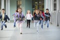 Young school kids running in a corridor in their school, close up Royalty Free Stock Photo