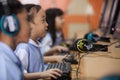 Young school kids start learning how to use a computer.