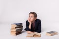 Young schoolboy daydreaming on a white background. Royalty Free Stock Photo