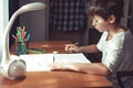 Young schoolboy doing homework or learning at home Royalty Free Stock Photo