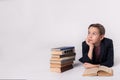 Young schoolboy dreaming on a white background. Royalty Free Stock Photo