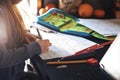 young schoolgirl does her writing exercises at home sise by side to parents working from home on laptop computer Royalty Free Stock Photo