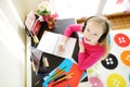 Young schoolgirl doing her homework with digital tablet at home. Child using gadgets to study. Education and distance learning for Royalty Free Stock Photo