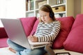 Young schoolgirl doing her homework with digital tablet at home. Child using gadgets to study. Education and distance learning for Royalty Free Stock Photo