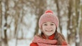 A young schoolgirl joyfully throws a snowball and breaks it with a palm when it falls. Emotions of joy. Winter fun in Royalty Free Stock Photo