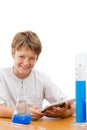 Young science student with tablet doing homework. Royalty Free Stock Photo