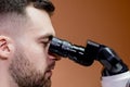 A young scientist conducting research with a microscope. Working with a microscope Royalty Free Stock Photo