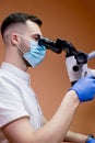 A young scientist conducting research with a microscope. Working with a microscope Royalty Free Stock Photo