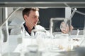 Young scientist conducts chemical experiments with liquids in science laboratory Royalty Free Stock Photo