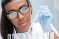 Young scientist in eyeglasses working with test tubes in chemical lab Royalty Free Stock Photo