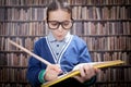 Young scientist, hustler with glasses in the library, with a hug Royalty Free Stock Photo