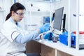 Young scientist loads pipette with sample for dna examination