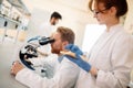 Young scientist looking through microscope in laboratory Royalty Free Stock Photo