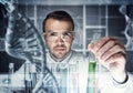 Young scientist mixing reagents in glass flask in clinical laboratory Royalty Free Stock Photo