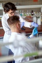 Young scientists observing the chemical in the test tube at the laboratory. Science, chemistry, lab, people