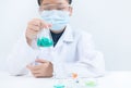 Young Scientists shaking blue liquid chemical in Erlenmeyer flask isolated on white Royalty Free Stock Photo