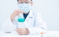 Young Scientists shaking blue liquid chemical in Erlenmeyer flask Royalty Free Stock Photo