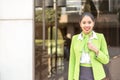 Young scort woman or crew smiling crossed arms green