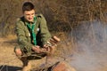 Young scout cooking his lunch over a fire