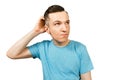 Young scratching head thinking man dressed in a blue t-shirt, isolated