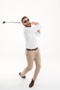 Young screaming emotional bearded man holding golfstick
