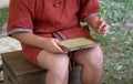 Young SCRIBE boy writes on a wax Tablet