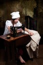 Young seamstress with old sewing machine