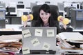 Young secretary with dumbbells in the office