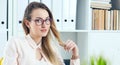 Young secretary flirting looking at camera in the office.