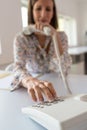 Young secretary sitting at her office desk dialing a telephone number Royalty Free Stock Photo