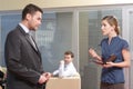 Young secretary talking to her boss in the office Royalty Free Stock Photo