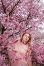 young seductive beauty redhead woman body dress and portrait, spring positive emotions in pink japanese cherry blossoms, sakura Royalty Free Stock Photo