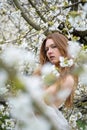 young seductive beauty redhead woman portrait, spring positive emotions in blooming apple tree blossoms Royalty Free Stock Photo