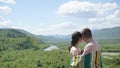 Young seductive naked couple covered by blanket softly embrasing on the green mountains background Royalty Free Stock Photo