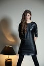 Young seductive woman in a black leather dress Royalty Free Stock Photo