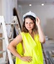 Young seductive woman builder in apartment during repair works Royalty Free Stock Photo