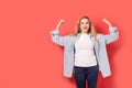 Young self-confident woman on a red background.