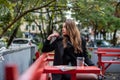 young self-sufficient and happy girl enjoys a walk around her hometown where autumn has come Royalty Free Stock Photo