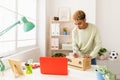 Young seller man preparing second hand package before send to buyer Royalty Free Stock Photo