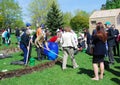 Young and senior people plant roses