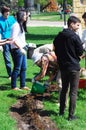 Young and senior people plant roses