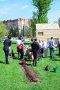 Young and senior people plant roses