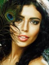 Young sensitive brunette woman with peacock feather eyes close u Royalty Free Stock Photo