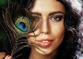 Young sensitive brunette woman with peacock feather eyes close up on green smiling, lifestyle people concept Royalty Free Stock Photo