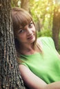 Young sensual girl leaning against a tree Royalty Free Stock Photo