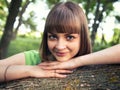 Young sensual girl leaning against a tree