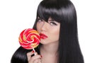 Young sensual girl sucking lollipop. Red lips. Makeup. Brunette Royalty Free Stock Photo